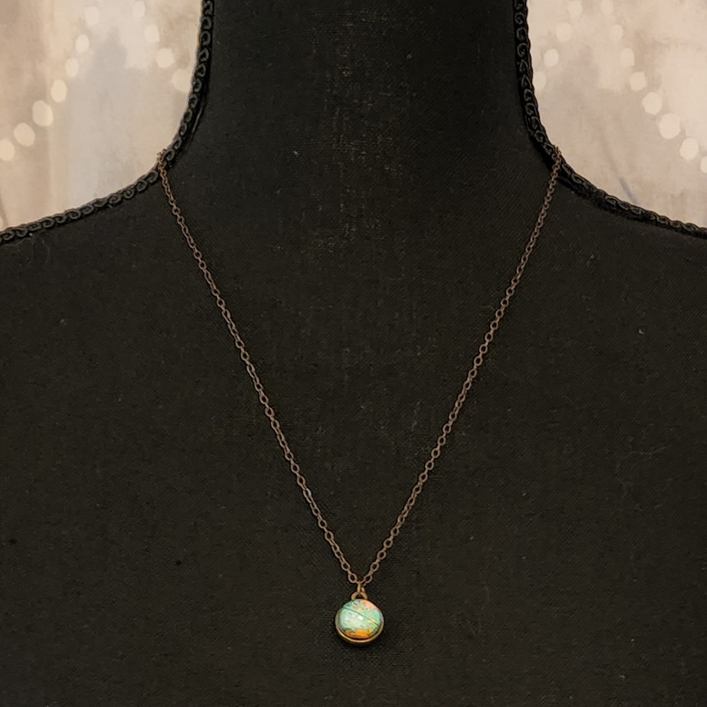 Plunder, brass tone globe necklace